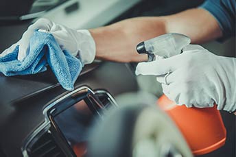 Car dashboard being sanitized